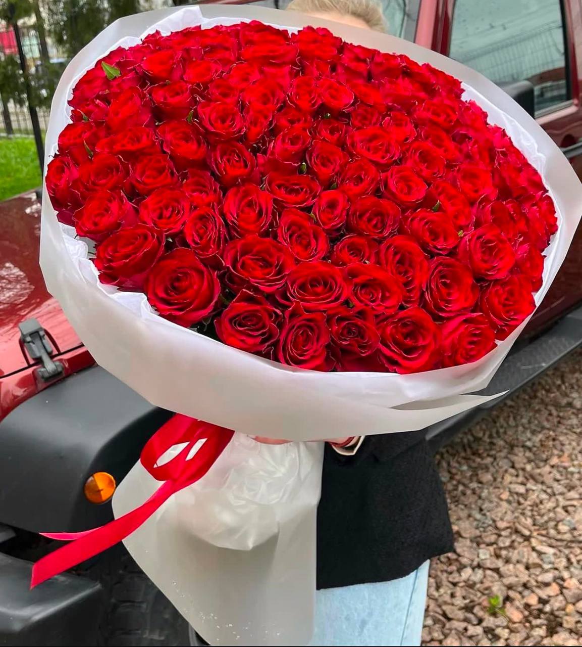 100 red roses in white wrapping