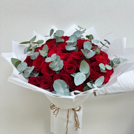 50 red roses with eucalyptus